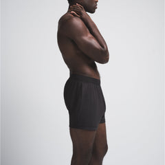 SKIMS COTTON MENS KNIT BOXER | ONYX ON A MODEL SIDE VIEW