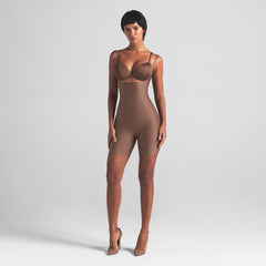 SKIMS BODY CORE SCULPT OPEN BUST MID THIGH BODYSUIT | JASPER ON A MODEL FRONT VIEW
