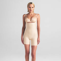 SKIMS BODY CORE SCULPT OPEN BUST MID THIGH BODYSUIT | SAND ON A MODEL FRONT VIEW