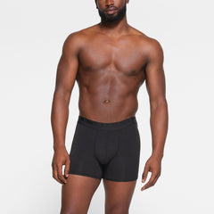 SKIMS STRETCH MENS 3" BOXER BRIEF 3-PACK WORN BY A MODEL IN FRONT VIEW | FOCUS: 0.0, 1.0, 0.9