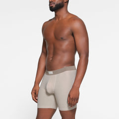 SKIMS COTTON MENS 5" BOXER BRIEF 3-PACK WORN BY A MODEL IN SIDE VIEW