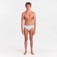 SKIMS STRETCH MENS BRIEF | CHALK ON A MODEL FRONT VIEW @ | FOCUS: 0.0, 1.0, 0.9