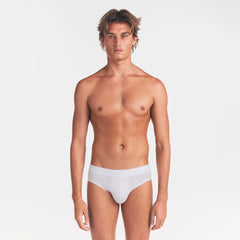 SKIMS STRETCH MENS BRIEF | CHALK ON A MODEL FRONT VIEW