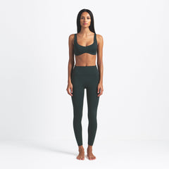 NikeSKIMS MATTE 26" LEGGING | DARK TEAL ON A MODEL FRONT VIEW @ | FOCUS: 0.0, 1.0, 0.9