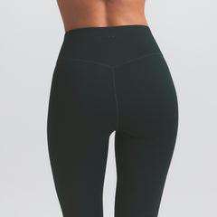NikeSKIMS MATTE SLIM FLARE LEGGING | DARK TEAL ON A MODEL SIDE VIEW @ | FOCUS: 0.0, 1.0, 0.9
