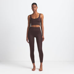 NikeSKIMS SHINE BONDED WAIST 26" LEGGING | PHOENIX ON A MODEL FRONT VIEW @ | FOCUS: 0.9, 0.1, 0.7