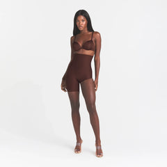 SKIMS BODY LEFT LEG SOLUTION SHORT | COCOA ON A MODEL FRONT VIEW @