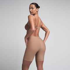 SKIMS BODY BUTT ENHANCING PADDED SHORT | SIENNA ON A MODEL SIDE VIEW