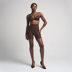 SKIMS BODY CORE SCULPT MID RISE SHORT | COCOA ON A MODEL FRONT VIEW
