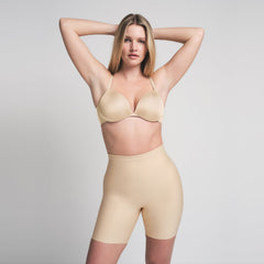 SKIMS BODY CORE SCULPT MID RISE SHORT | SAND ON A MODEL FRONT VIEW