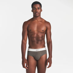 SKIMS COTTON RIB MENS BRIEF | JUNGLE ON A MODEL FRONT VIEW @ | FOCUS: 0.0, 1.0, 0.9