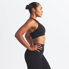 NikeSKIMS MATTE HIGH NECK BRA | OBSIDIAN ON A MODEL SIDE VIEW @ | FOCUS: 0.0, 1.0, 0.9
