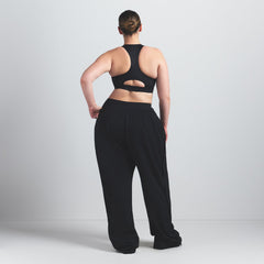 NikeSKIMS SHINE HIGH NECK BRA | OBSIDIAN ON A MODEL FRONT VIEW