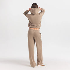 COTTON FLEECE STRAIGHT LEG PANT WITH EMBOSSED LOGO | LATTE ON A MODEL FRONT VIEW @ | FOCUS: 0.0, 1.0, 0.9