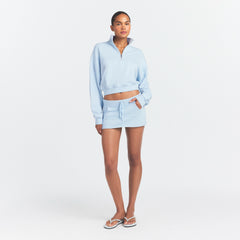DRAPEY FRENCH TERRY MINI SKIRT | POWDER BLUE ON A MODEL FRONT VIEW @ | FOCUS: 0.0, 1.0, 0.9