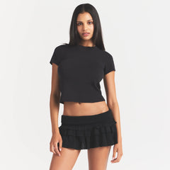 SHEER KNIT RUFFLE MINI SKIRT | ONYX ON A MODEL FRONT VIEW @ | FOCUS: 0.0, 1.0, 0.9