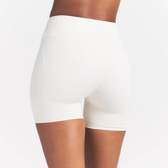 NikeSKIMS MATTE 5" BIKER SHORT | IVORY ON A MODEL