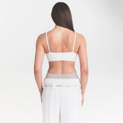 NikeSKIMS MATTE MICRO SCOOP BRA | IVORY ON A MODEL