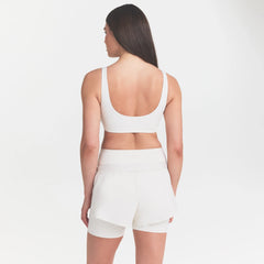 NikeSKIMS MATTE SCOOP NECK BRA | IVORY ON A MODEL