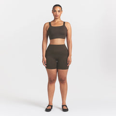 NikeSKIMS MATTE WIDE STRAP BRA | DARK SEPIA ON A MODEL FRONT VIEW @ | FOCUS: 0.9, 0.1, 0.7