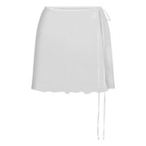 SKIMS ROMANCE TIE SIDE MINI SKIRT | IVORY LAYS FLAT ON A WHITE BACKGROUND | FLT
