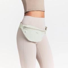 NikeSKIMS ACCESSORIES FANNY PACK | TALC ON A MODEL SIDE VIEW @ | FOCUS: 0.0, 1.0, 0.9