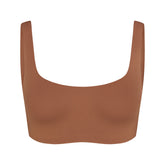 NikeSKIMS MATTE SCOOP NECK BRA | CAROB BROWN & LAYS FLAT ON A WHITE BACKGROUND | FLT