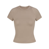 NikeSKIMS AIRY DRI-FIT BABY T-SHIRT | DRIFTWOOD FLAT ON A WHITE BACKGROUND | FLT