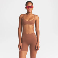 NikeSKIMS MATTE 5" BIKER SHORT |CAROB BROWN ON A MODEL SIDE VIEW @ | FOCUS: 0.0, 1.0, 0.9