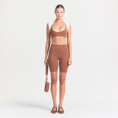 NikeSKIMS MATTE 7" BIKER SHORT | CAROB BROWN ON A MODEL FRONT VIEW @ | FOCUS: 0.0, 1.0, 0.9