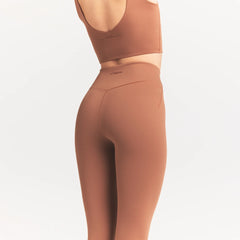 NikeSKIMS MATTE 29" LEGGING | CAROB BROWN ON A MODEL SIDE VIEW @ | FOCUS: 0.0, 1.0, 0.9