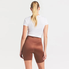 NikeSKIMS SATIN SHINE BONDED WAIST 7" BIKER SHORT | CAROB BROWN ON A MODEL SIDE VIEW @ | FOCUS: 0.0, 1.0, 0.9
