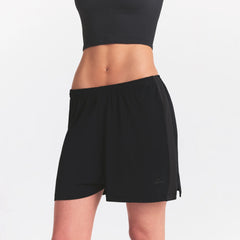 NikeSKIMS STRETCH KNIT DOLPHIN SHORT | OBSIDIAN ON A MODEL SIDE VIEW @ | FOCUS: 0.0, 1.0, 0.9