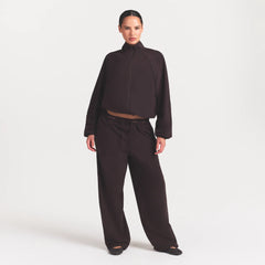 NikeSKIMS STRETCH NYLON OVERSIZED PANT | DARK ROAST ON A MODEL FRONT VIEW @ | FOCUS: 0.0, 1.0, 0.9
