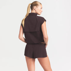 NikeSKIMS STRETCH NYLON RUNNER SHORT | DARK ROAST ON A MODEL SIDE VIEW @ | FOCUS: 0.0, 1.0, 0.9