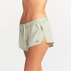 NikeSKIMS STRETCH NYLON RUNNER SHORT | TALC ON A MODEL SIDE VIEW @ | FOCUS: 0.0, 1.0, 0.9
