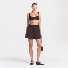 NikeSKIMS STRETCH NYLON 5" TRACK SHORT | DARK ROAST ON A MODEL FRONT VIEW @ | FOCUS: 0.0, 1.0, 0.9