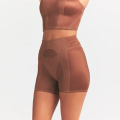 NikeSKIMS SATIN SHINE PANELED 5” BIKER SHORT | CAROB BROWN ON A MODEL SIDE VIEW @ | FOCUS: 0.0, 1.0, 0.9