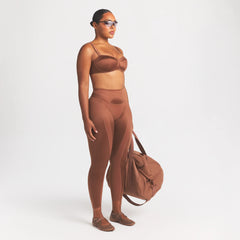 NikeSKIMS SATIN SHINE PANELED 26” LEGGING | CAROB BROWN ON A MODEL FRONT VIEW @ | FOCUS: 0.0, 1.0, 0.9
