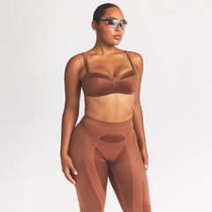 NikeSKIMS SATIN SHINE PANELED 26” LEGGING | CAROB BROWN ON A MODEL SIDE VIEW @ | FOCUS: 0.0, 1.0, 0.9