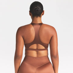 NikeSKIMS SATIN SHINE RACERBACK BRA | CAROB BROWN ON A MODEL SIDE VIEW @ | FOCUS: 0.0, 1.0, 0.9