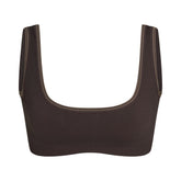 NikeSKIMS RIBBED SEAMLESS MICRO SCOOP BRA | PHOENIX FLAT ON A WHITE BACKGROUND | FLT