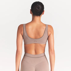 NikeSKIMS RIBBED SEAMLESS MICRO SCOOP BRA | DRIFTWOOD ON A MODEL SIDE VIEW @ | FOCUS: 0.0, 1.0, 0.9
