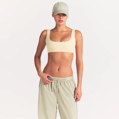 NikeSKIMS RIBBED SEAMLESS MICRO SCOOP BRA | LEMON DROP ON A MODEL FRONT VIEW @ | FOCUS: 0.0, 1.0, 0.9