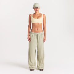 NikeSKIMS RIBBED SEAMLESS MICRO SCOOP BRA | LEMON DROP ON A MODEL FRONT VIEW @ | FOCUS: 0.0, 1.0, 0.9