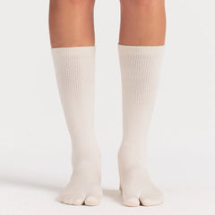 NikeSKIMS ACCESSORIES RIFT KNEE HIGH SOCK | LIGHT OREWOOD BROWN ON A MODEL SIDE VIEW @ | FOCUS: 0.0, 1.0, 0.9