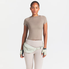 NikeSKIMS AIRY DRI-FIT BABY T-SHIRT | DRIFTWOOD ON A MODEL SIDE VIEW @ | FOCUS: 0.0, 1.0, 0.9