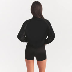 NikeSKIMS STRETCH KNIT LONG SLEEVE HALF ZIP | OBSIDIAN ON A MODEL SIDE VIEW @ | FOCUS: 0.0, 1.0, 0.9
