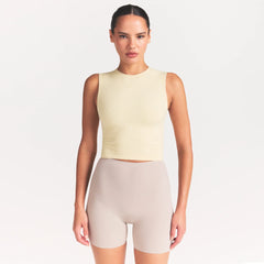 NikeSKIMS RIBBED SEAMLESS MUSCLE TANK | LEMON DROP ON A MODEL SIDE VIEW @ | FOCUS: 0.0, 1.0, 0.9
