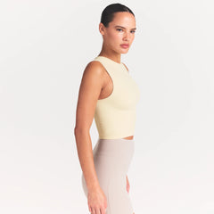 NikeSKIMS RIBBED SEAMLESS MUSCLE TANK | LEMON DROP ON A MODEL SIDE VIEW @ | FOCUS: 0.0, 1.0, 0.9